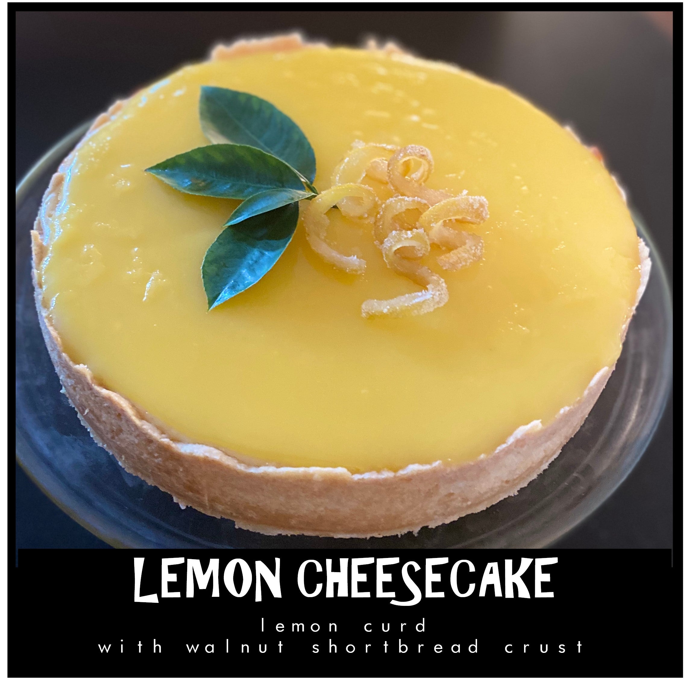 Fresh Lemon Curd Cheesecake  with hand molded toasted almond and shortbread crust garnished with candied lemons curls and fresh lemon leaves