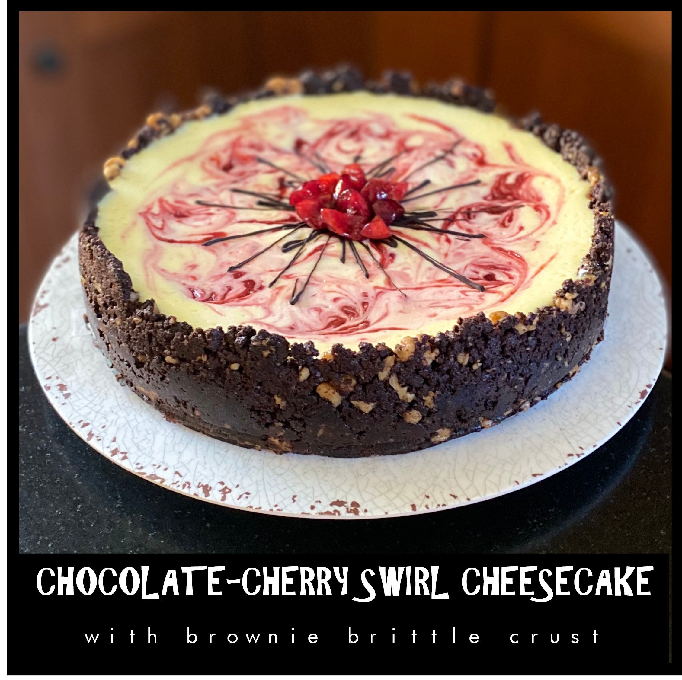 Fresh cherries swirled in a creamy cheesecake filling surrounded by a hand pressed brownie brittle crust topped with chocolate drizzle and chopped cherries