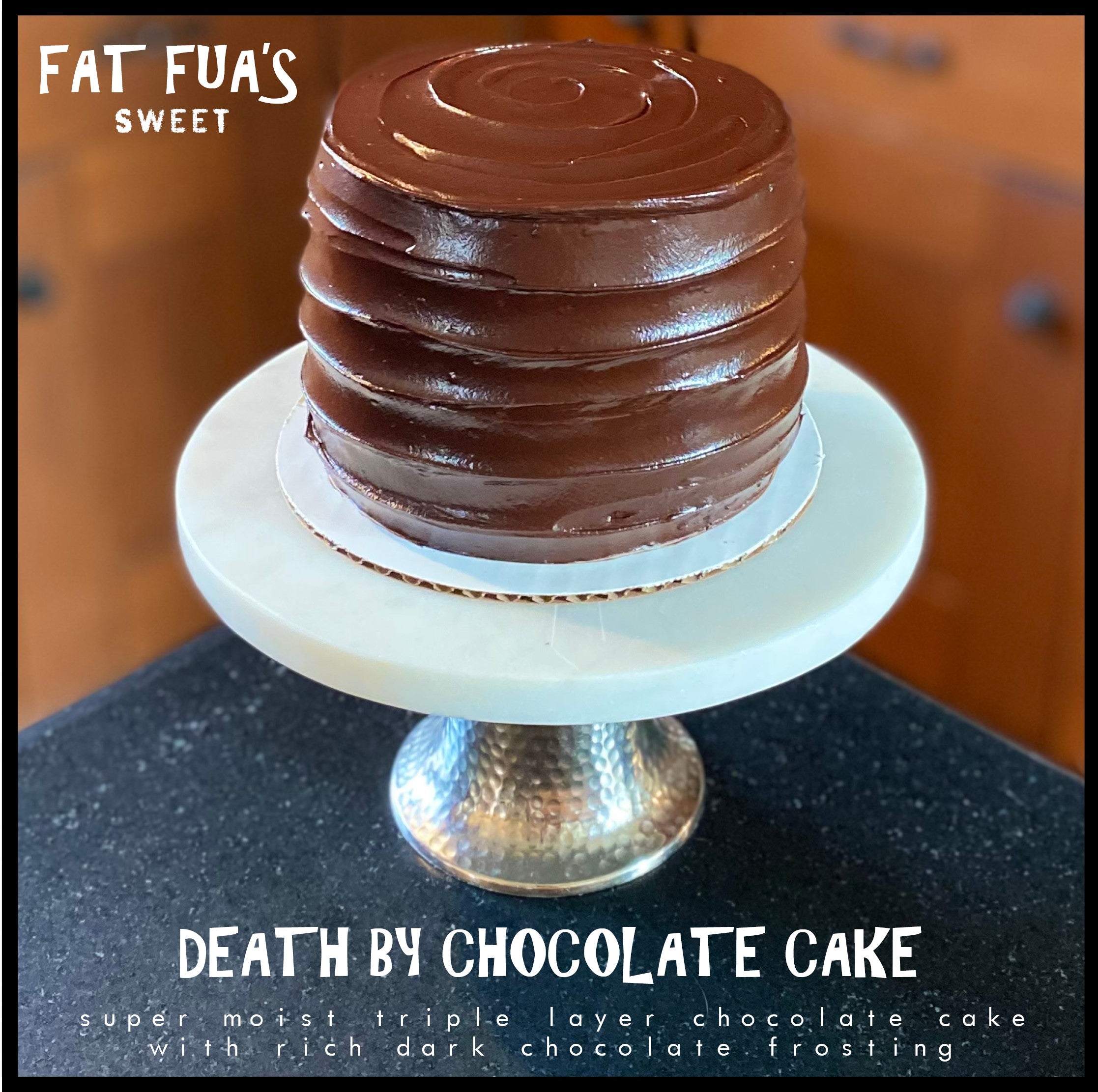 Jr size Death by Chocolate Cake on a marble cake stand  3 layers of moist dark chocolate cake swirled with rich dark chocolate ganache' a chocolate lovers delight