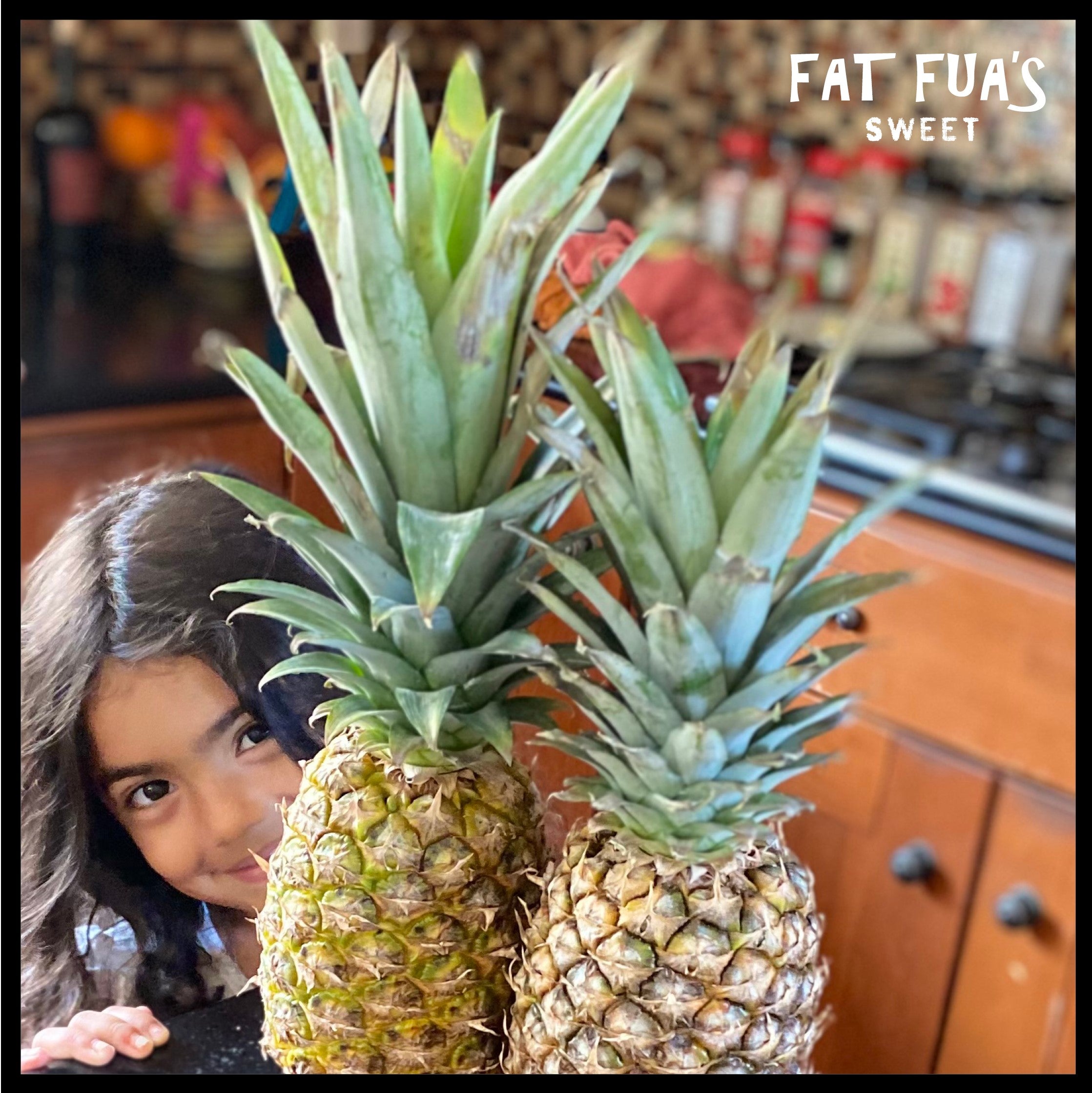 Little Fua Girl peaking from behind a pineapple