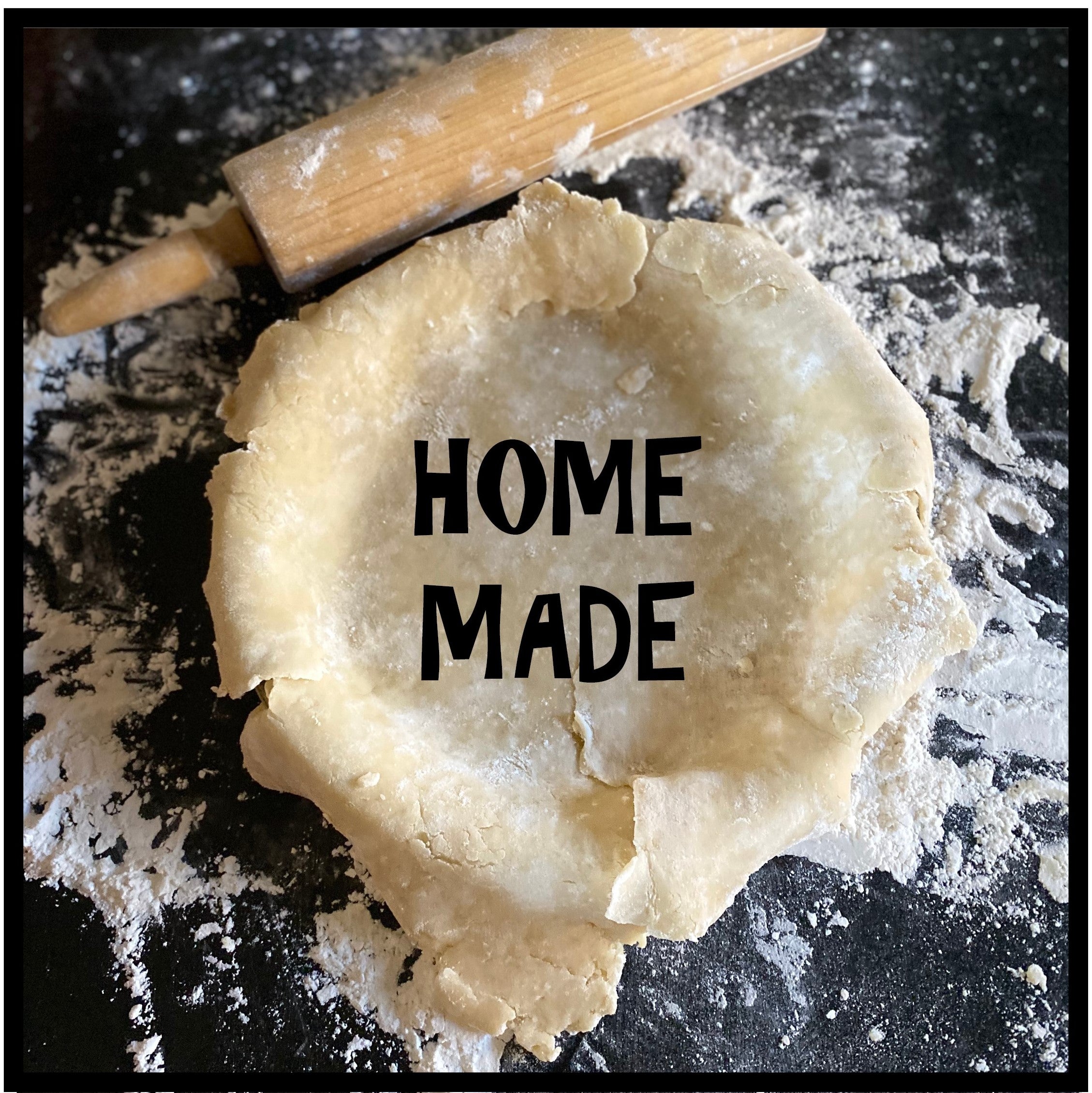 Flaky Hand made pie crust being rolled out on kitchen counter