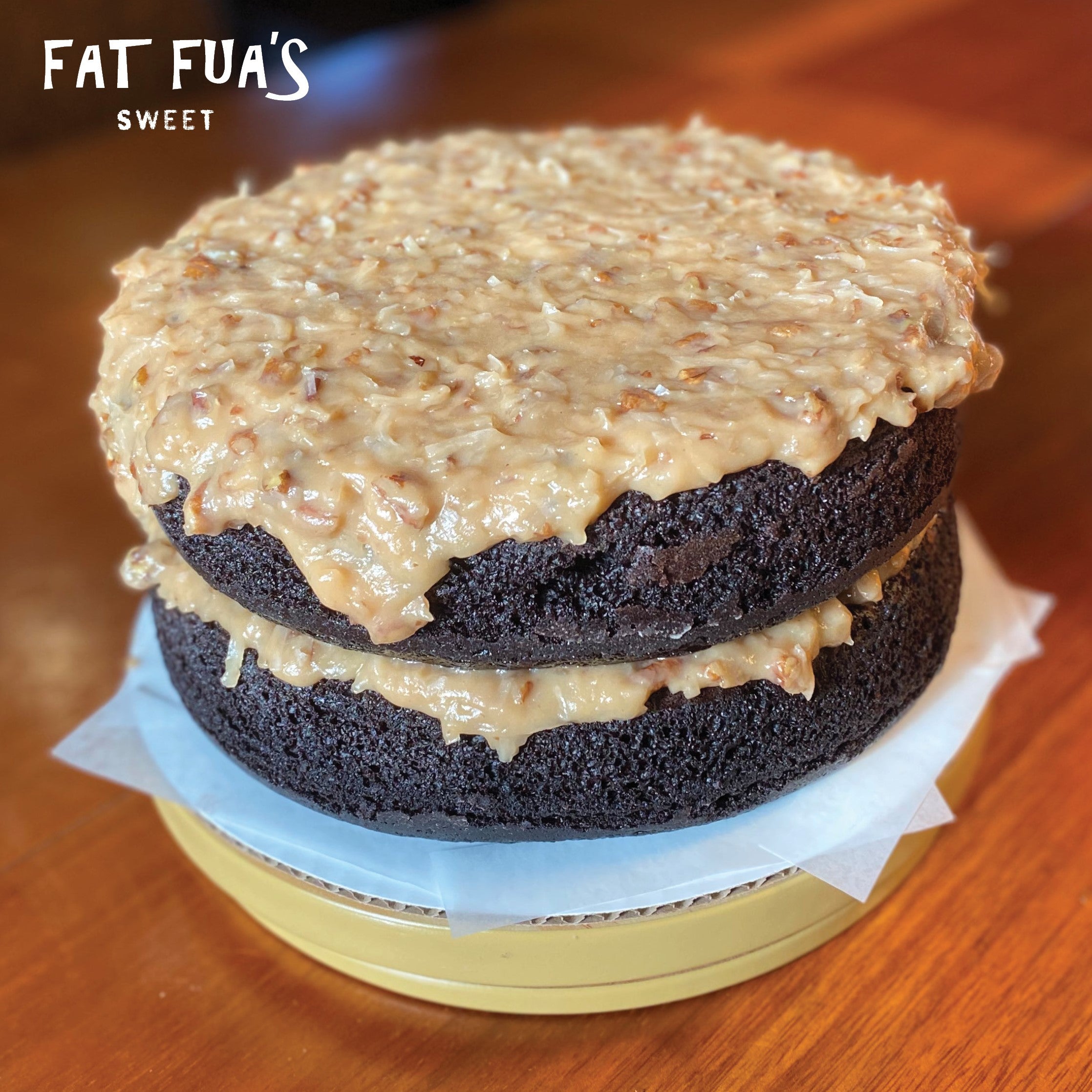 Inside vie of Fat German Chocolate cake showing 2 layers of moist of dark chocolate cake with made from scratch creamy butter pecan and coconut frosting
