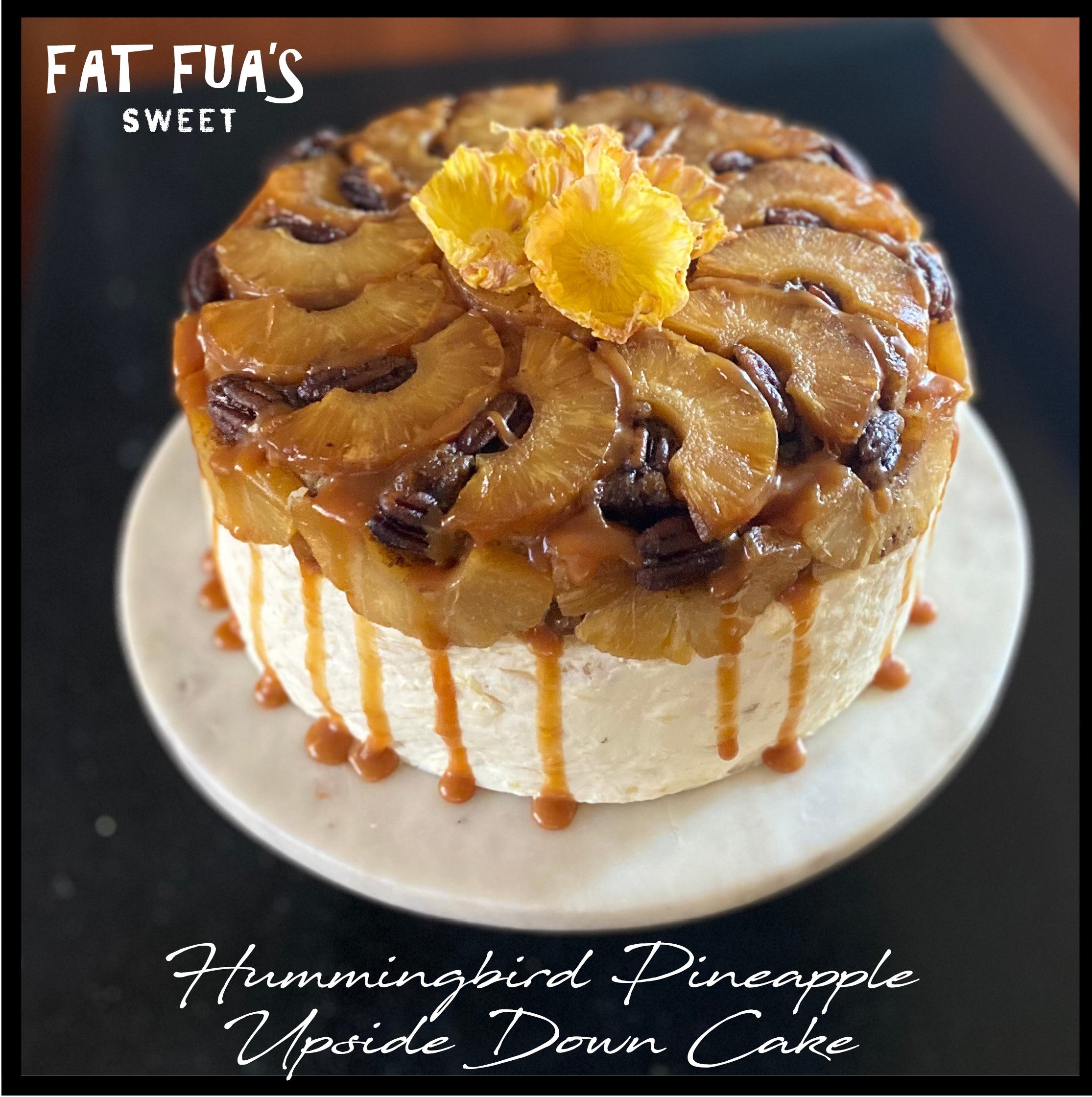 A Scrumptious Pineapple Upside Down Cake Rests on Top of Two Layers of  Luscious Hummingbird Cake filled with Pineapple, Banana and Pecans.  Frosted with a Whipped Pineapple and Cream Frosting and A Salted Caramel Drizzle.  Garnished with Hand Made Pineapple Flowers . 